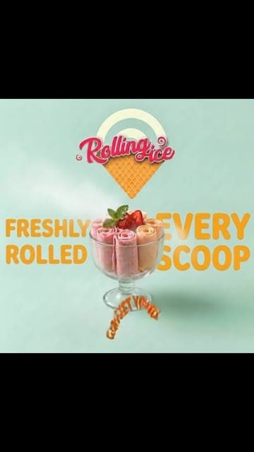 Strawberry rolled ice cream served in a glass coupe with fresh mint